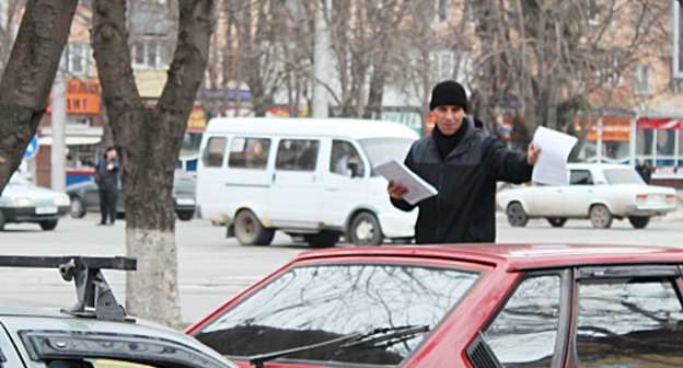 Участник пикета против деятельности ОАО "Электроцинк" раздает листовки. Владикавказ, 16 февраля 2013 г. Фото Эммы Марзоевой для "Кавказского узла"