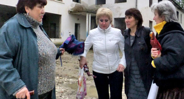 Жители микрорайона "Малый Ахун" возле охраняемой территории бывшего детского сада. Сочи, 16 февраля 2013 г. Фото Светланы Кравченко для "Кавказского узла"