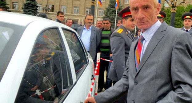 Участник карабахской войны Карен Саркисян рядом со своей машиной, которая была подарена во время торжественной церемонии открытия административного здания Союза воинов-освободителей Арцаха (Карабаха). Степанакерт, 9 мая 2013 г. Фото Алвард Григорян для "Кавказского узла"