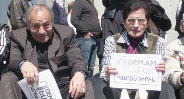 Участники митинга против пенсионных реформ. Надпись на листовках - "DEM.AM/Я против" Армения, Ереван, 22 марта 2014 г. Фото Армине Мартиросян для "Кавказского узла"

