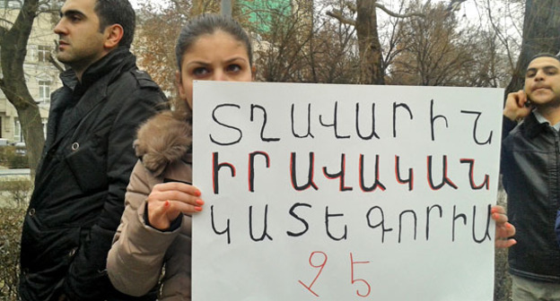 Участница пикета с требованием передать Пермякова армянским правоохранителям. Надпись на плакате "По-мужски - это не правовая категория". Ереван, 12 февраля 2015 г. Фото Армине Мартиросян для "Кавказского узла"