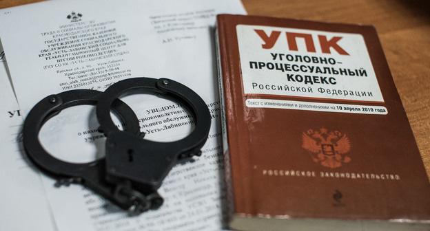Уголовный кодекс и наручники. Фото Елены Синеок, Юга.ру