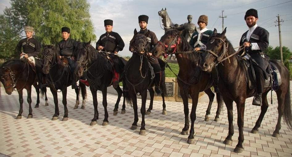 Участники конного перехода в ауле Афипсип на фоне памятника Кизбечу Тугужоко, май 2018 года. Автор фото Руслан Хакуй.