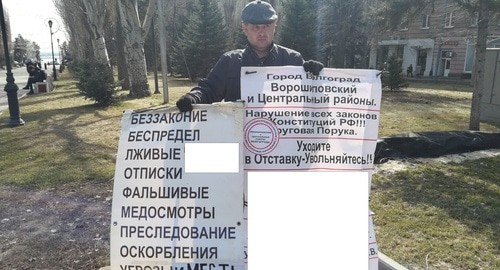 Константин Фельдешеров во время одиночного пикета в центре Волгограда. 5 марта 2020 года. Фото Татьяны Филимоновой для "Кавказского узла". Надпись на плакате, и в частности названия конкретных ведомств, частично скрыта из-за ограничений СМИ нормативными актами.