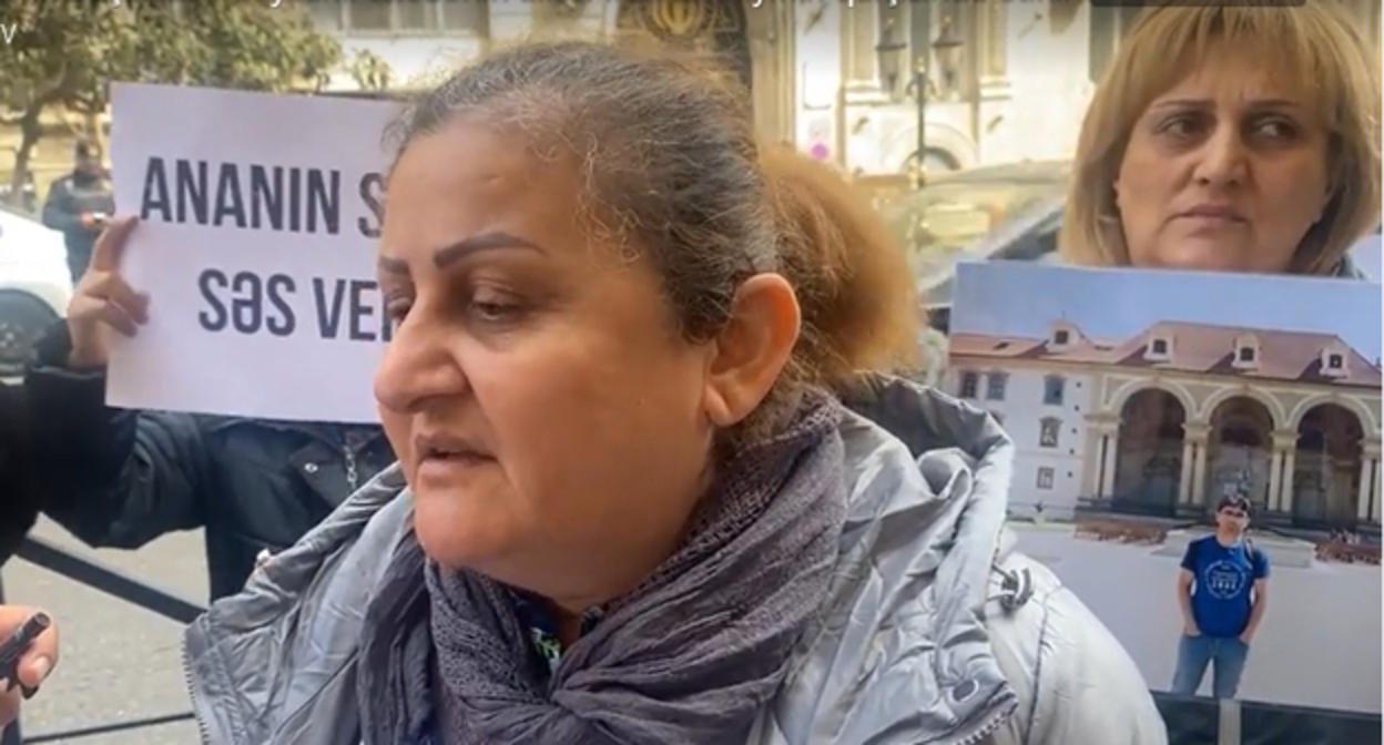 Родственники Фарида Сафарли на акции в Баку, надпись на плакате: "Ответьте на зов  матери", стоп-кадр видео Meydan.Tv
