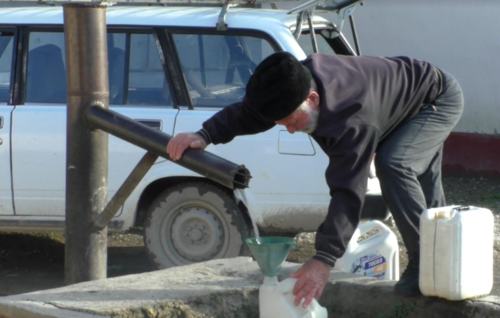 Житель Умашаула набирает воду. Стоп-кадр видео "Кавказского узла", https://youtu.be/X45ODib0-Mg
